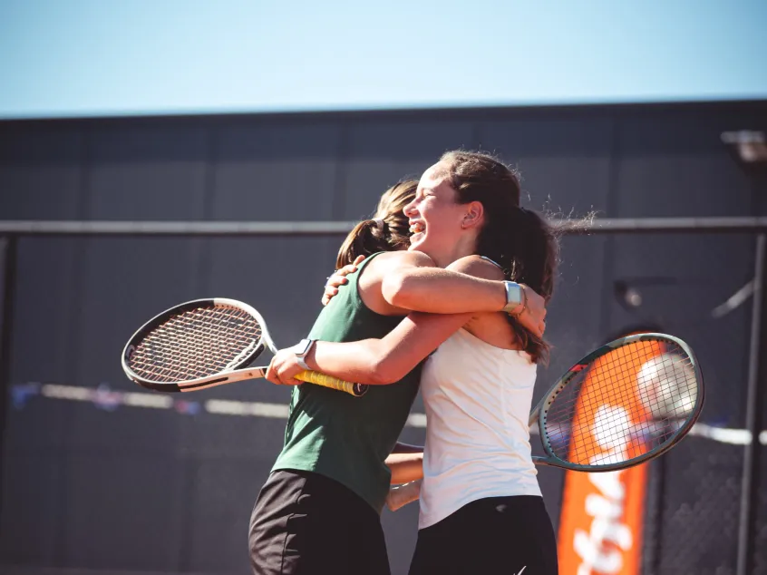 Two tennis players hug each other